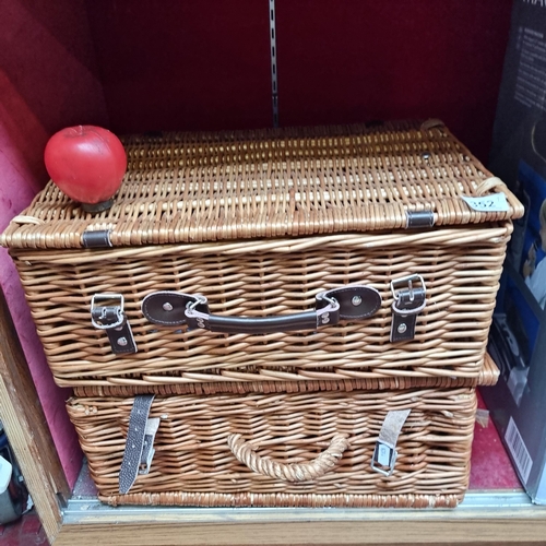 352 - Two vintage wicker picnic basket, complete with leather straps, embodying pastoral charm.