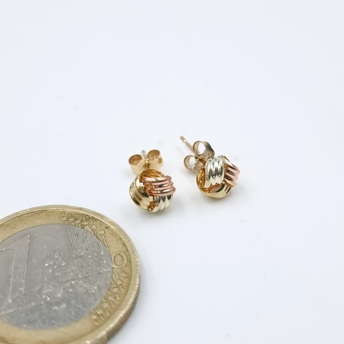 A pair of  very attractive nine carat gold, two colour stud earrings. With yellow, white rose gold. Weight - .44 grams.