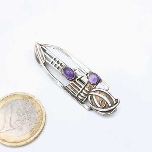 64 - A sterling silver Rennie Macintosh brooch set with Cabochons within a Celtic design. Length of brooc... 