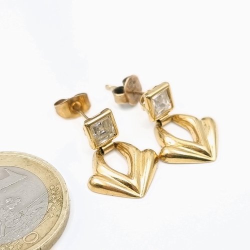 69 - Star Lot : A very attractive pair of 18 carat gold (750) stud earrings set with gemstone detailing. ... 