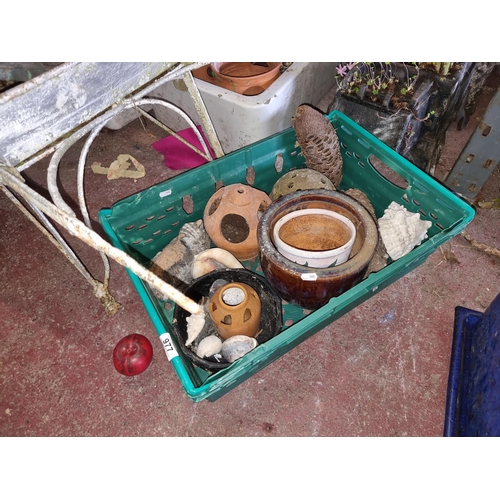 977 - A mixed crate full of garden ornaments and planters.