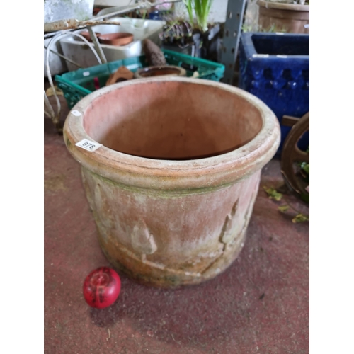 978 - A very large terracotta planter, presenting a charming patina and silhouette detailing.