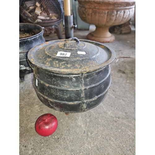 982 - A vintage cast iron cauldron with lid, showcasing storied patina.