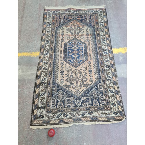 377 - Star Lot : A vintage hand made Persian rug, showcasing traditional patterns and a rich color palette... 