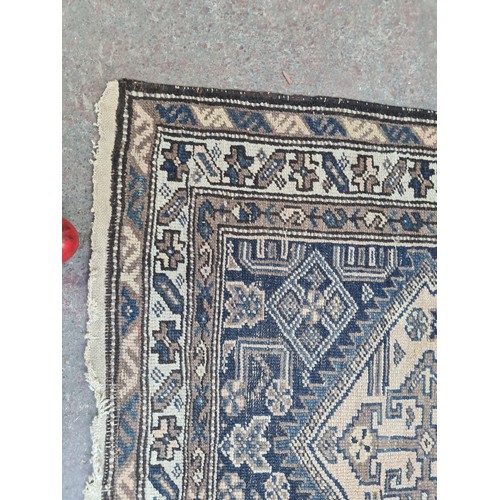 377 - Star Lot : A vintage hand made Persian rug, showcasing traditional patterns and a rich color palette... 