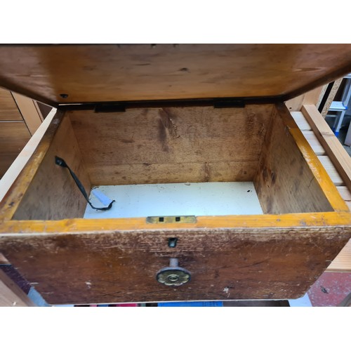 386 - An antique oak storage box with brass handle, exuding antique charm and functional elegance.