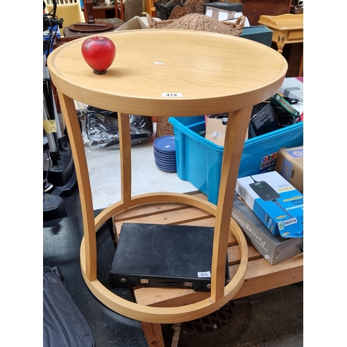 414 - A contemporary round occasional beech wine table.