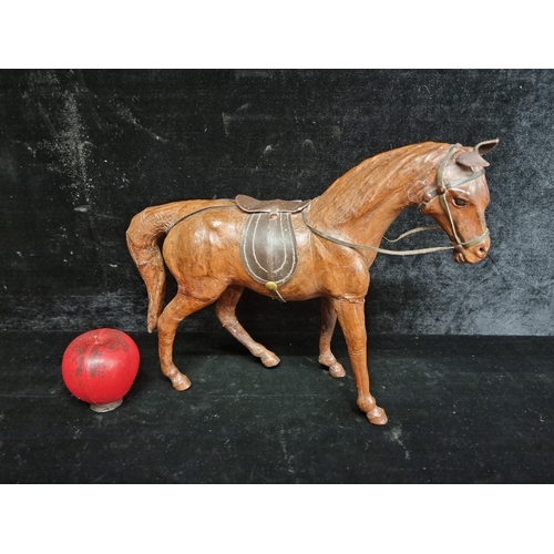 244 - A gorgeous large leather figure of a horse with leather saddle and reins.