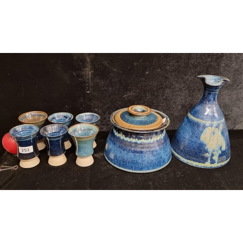 253 - Eight Louis Mulcahy studio pottery items including a set of six goblets, a large carafe jug and a li... 