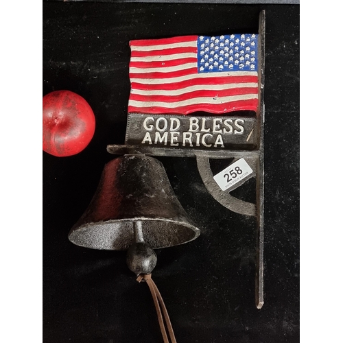 258 - A wall mounted cast iron bell featuring American flag.