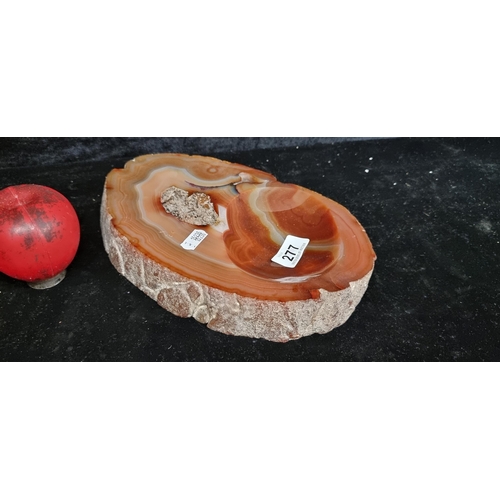 277 - A large heavy polished agate slice with tray design. Wonderful deep rust red and grey blue veining.