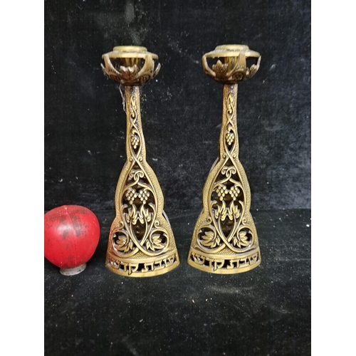 278 - A pair of Shabbat brass candle sticks with elaborate pierced design.