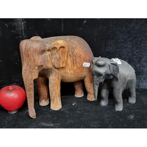 287 - Two super carved wooden elephants with bone eye detailing. Carved from heavy exotic hard wood.