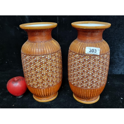 303 - A pair of unusual vintage Chinese porcelain vases intricately covered with woven bamboo. In VGC.