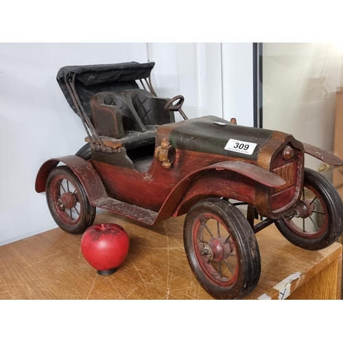 309 - A striking vintage large wooden model of an antique car.