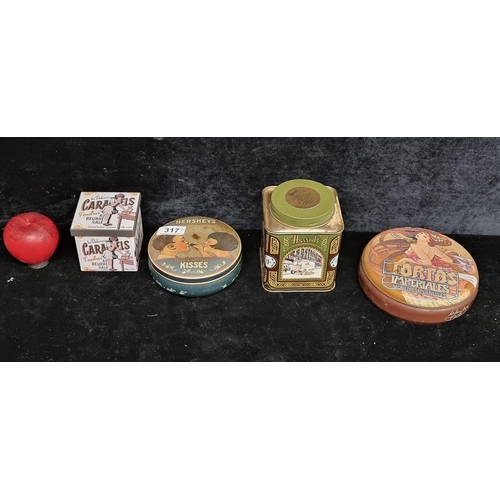 317 - A selection of four vintage advertising tins including and American Hershey's example and an English... 