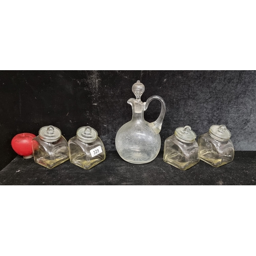 329 - Five pieces of elegant glassware including a water jug with stopper and four lidded storage jars.