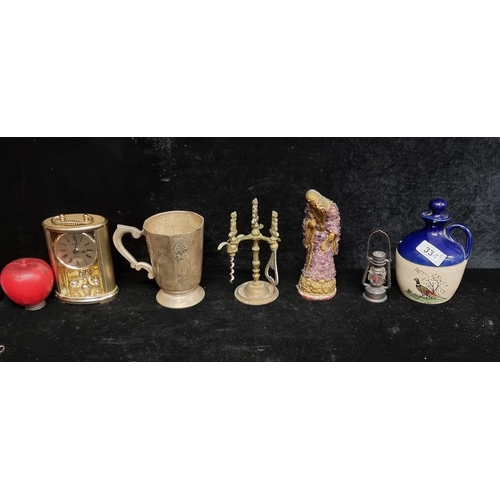 334 - A mixed lot of six items including a stoneware flagon, a miniature minors lamp and a brass mantel cl... 