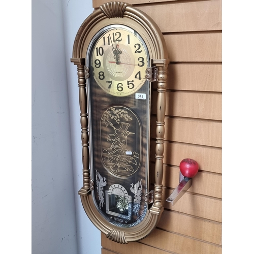 342 - A striking retro Miron Quartz wall clock. Features reverse painted mirror glass to front and crane b... 