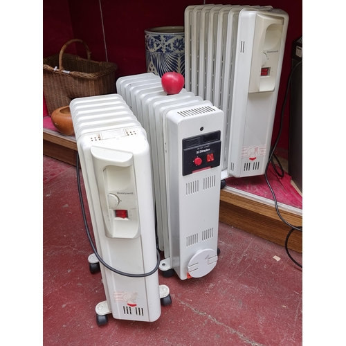 367 - Two oil filled storage heaters, two Honeywell examples along with a Dimplex example. Both in working... 