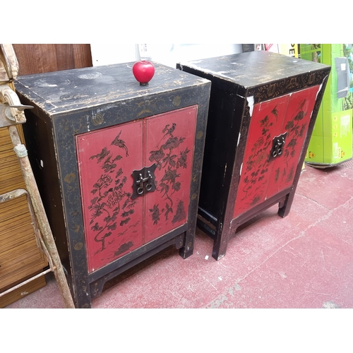 378 - Two oriental style bedside lockers, each with two doors and shelf inside. Featuring hand painted fol... 