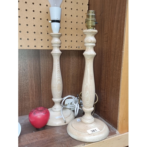 381 - A pair of turned wooden lamp bases.