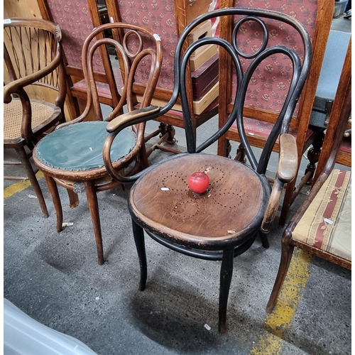 630 - Two classic early 20th century bentwood bistro chairs, one example boasting a seat upholstered in le... 