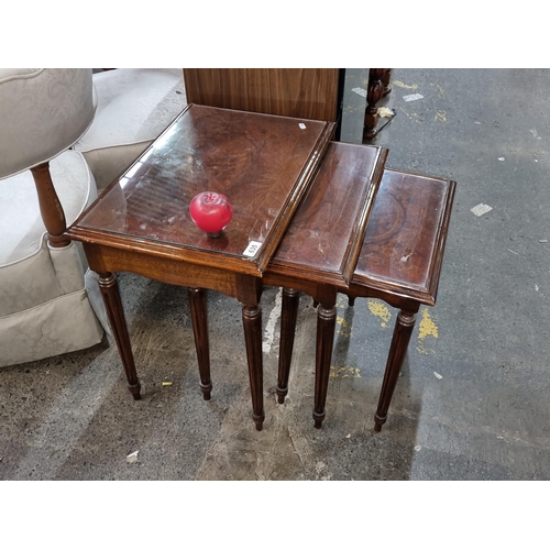 635 - A lovely set of three vintage nesting tables,  protected under tempered glass, all held on stylish f... 