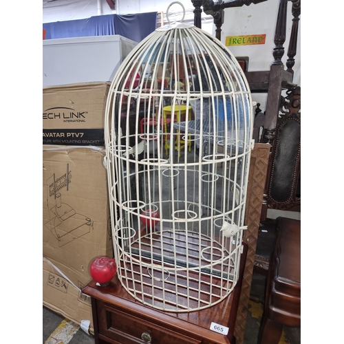 670 - A vintage style metal birdcage with a rustic white painted surface and mirror to back with bird deco... 