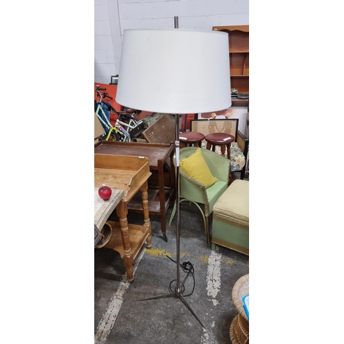 680 - A classic floor lamp with a minimalist design and a large white shade with tripod base , perfect for... 