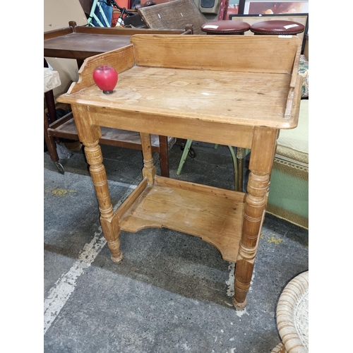 681 - Vintage antique pine wash stand featuring gallery back, wooden turned legs and additional lower shel... 