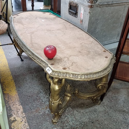 617 - A vintage coffee table with gilt border and legs in the form of people supporting the table with scr... 