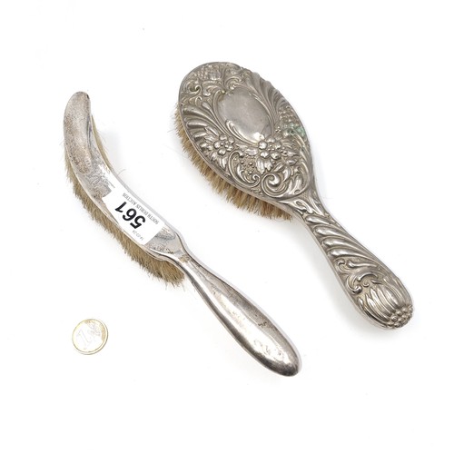 561 - A collection of two items. A sterling silver hallmarked London crumb brush together with a sterling ... 