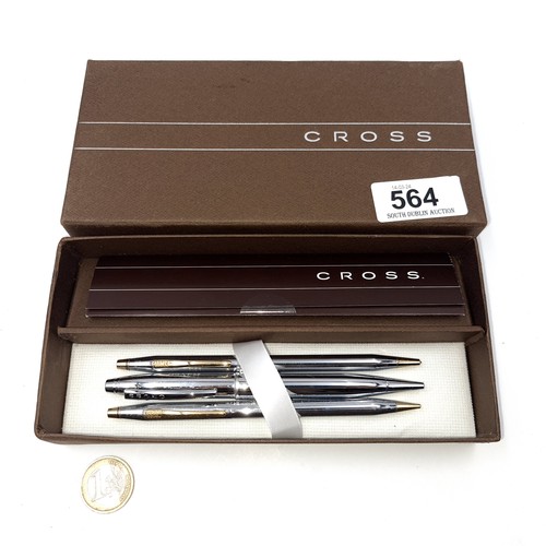 564 - A collection of three Cross pens. Two ball point, one propelling pencil. Each with polished chrome b... 