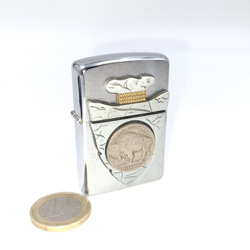 566 - An unused Zippo lighter featuring a silver content buffalo nickle.