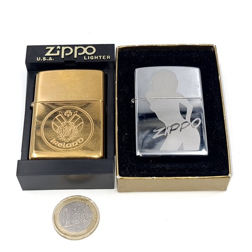 568 - An unused Zippo clear sky lighter together with a solid brass Ireland lighter.