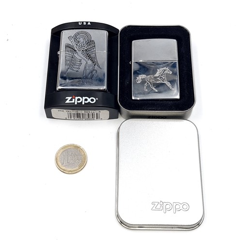 579 - Two unused Zippo flint lighters set with a futuristic figure together with a Stallion example. Prese... 