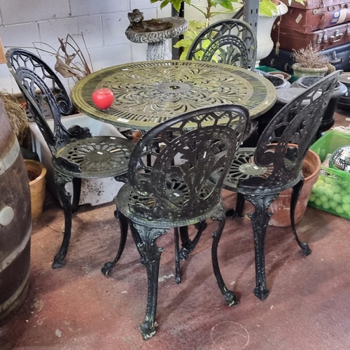 912 - Star Lot : An intricate wrought iron garden set, featuring a table and four chairs with detailed vin... 