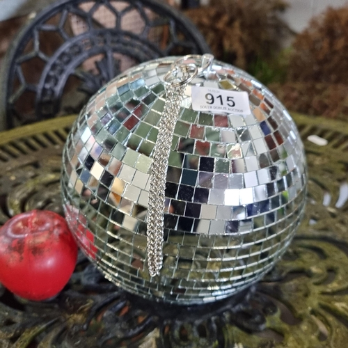 915 - Vibrant disco ball with reflective mirror tiles and silver chain, perfect for retro-themed decor or ... 