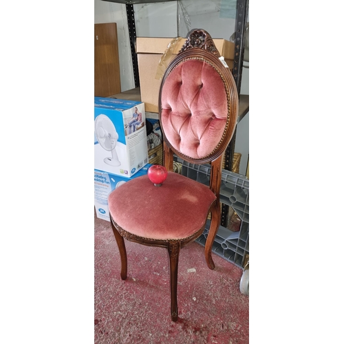 956 - Ornate Victorian-style chair with plush rose velvet upholstery and intricately carved mahogany frame... 