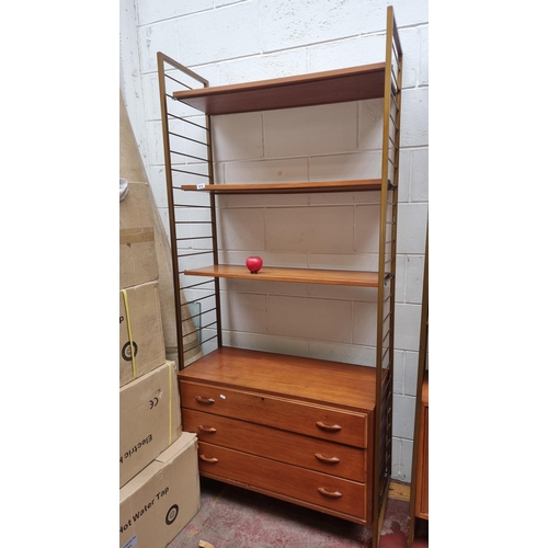 974 - Star Lot : Vintage mid-century modern teak shelving unit with integrated drawers, displaying Danish ... 