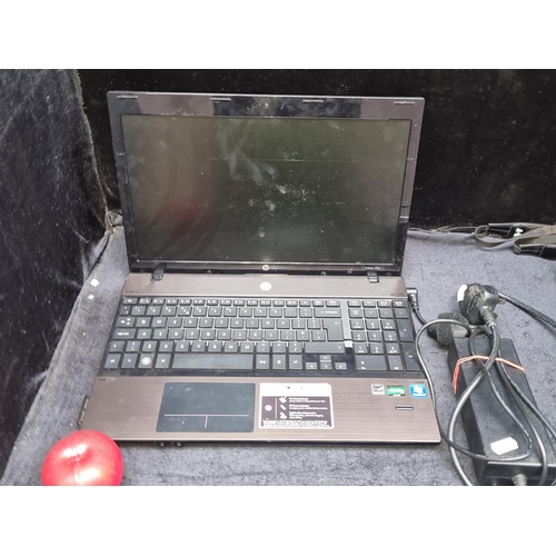 987 - An HP ProBook laptop with charger.