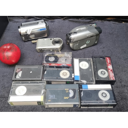 988 - Two mini camcorders (JVC and Sony) and a canon cybershot camera and a selection of VHS-C tapes. Just... 