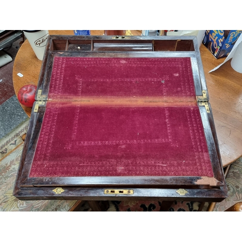 772 - A handsome antique mahogany writing box. Featuring brass hardware and a burgundy suede writing slope... 