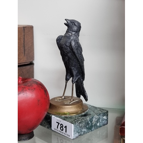 781 - A charming cast metal possibly bronze  sculpture of a sparrow held on a gold and onyx plinth base.