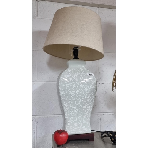 815 - A large stylish lamp with hand painted design to base and a lovely cream fabric shade.