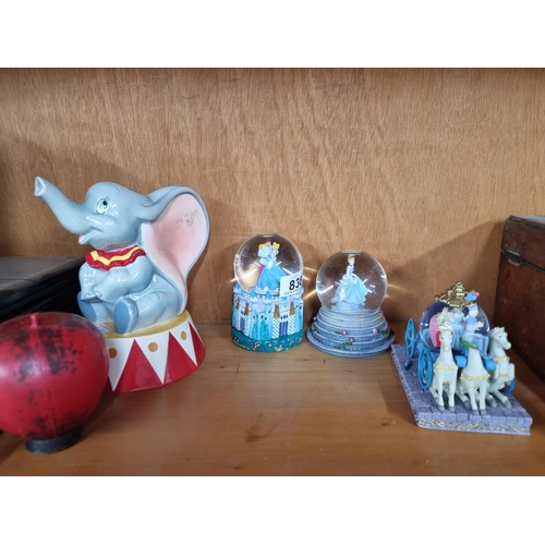 838 - A lovely collection of Disney ornamental items including three Cinderella themed snow globes and 'Du... 