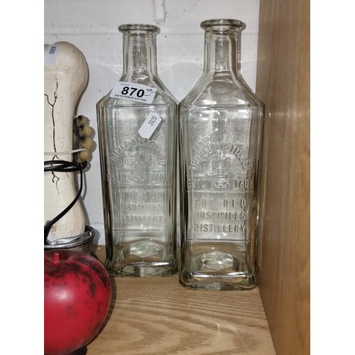 870 - Two triple distilled Bushmills glass whiskey bottles in very good condition