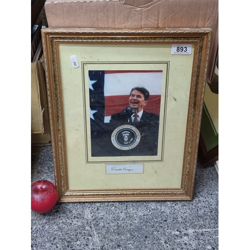 893 - A framed display showing the hand written signature of president Ronald Reagan, along with a print o... 