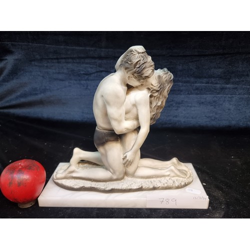 789 - A stunning heavy stone sculpture of an embracing loving couple signed by the artist D'ADOR. Sat on a... 